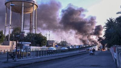 Iraqi Anti-government demonstrators block a road with debris and burning tires in the southern Iraqi city of Nasiriyah. AFP