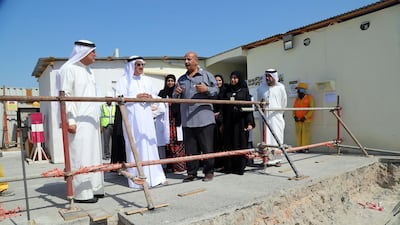 Dubai Health Authority officials survey work at Latifa Hospital that's undergoing an expansion that will double its capacity. DHA