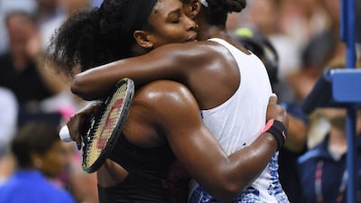 Serena Williams hugs sister Venus after their quarter-final match on Tuesday at the US Open. Stan Honda / AFP