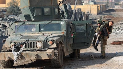 A member of Iraq’s security forces carries a wounded colleague in Mosul’s eastern Intisar neighbourhood on December 30, 2016, during a renewed military push against ISIL in the northern city. Ahmad Al Rubaye / AFP