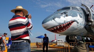 A man takes photo of the Embraer E190-E2 Commercial Jet. AP Photo
