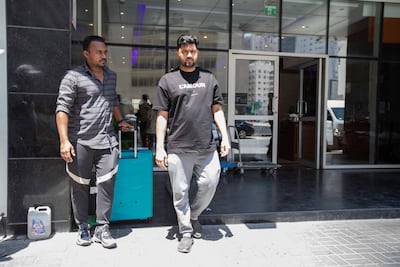 Najed Nujumuddin, left, who lives in the building with his friend Noufal Faziludeen on the upper floor of the high-rise building caught on fire on Thursday night. Leslie Pableo for The National