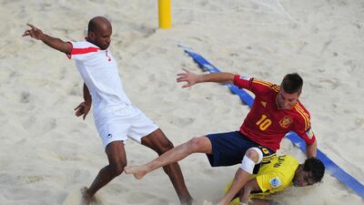 Llorenc, of Spain, is challenged by Mohamed Al Jasmi, the UAE goalkeeper, and Qambar Mohammad Sadeqi during their Beach Soccer World Cup match. Shaun Botterill / Fifa / Fifa via Getty Images