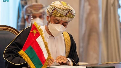 Omani Foreign Minister Sayyid Al Busaidi signing a deal.