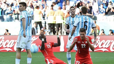 Switzerland defenders Fabian Schar, second left, and Johan Djourou react after missing the shot on goal in their loss to Argentina at the 2014 World Cup in Sao Paulo, Brazil. Anne-Christine Poujoulat / AFP