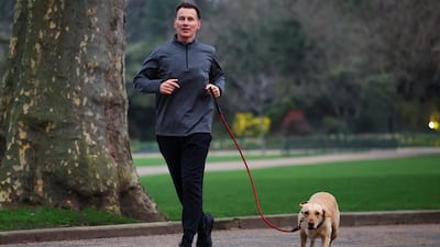 Mr Hunt gets some exercise with his dog Poppy before his budget statement. Reuters
