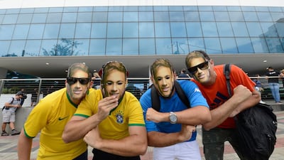 Supporters wear Neymar face masks as they pose for a photo outside the Mater Dei Hospital, where he underwent surgery. Eugenio Savio / AP Photo