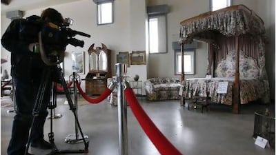 A cameraman films a bedroom set belonging to Bernard Madoff ahead of the US Marshals Service auction.