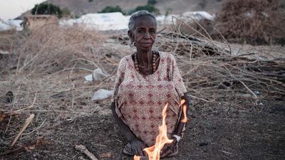Ethiopian Arrafu Mbaye, 70-year-old who fled the Tigray conflict, burns wood to cook at the Um Raquba refugee camp in Sudan's eastern Gedaref state. AFP