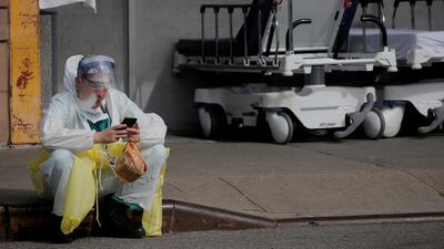 A healthcare worker sits on the curb as he uses a vaping device while taking a break outside Maimonides Medical Center during the outbreak of coronavirus in the Brooklyn borough of New York City, New York, US. Reuters