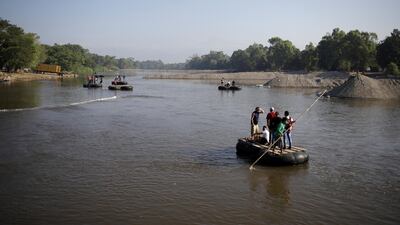 People cross Suchiate river on rafts, between Mexico and Guatemala, as seen from Ciudad Hidalgo, Mexico. REUTERS/Andres Martinez Casares