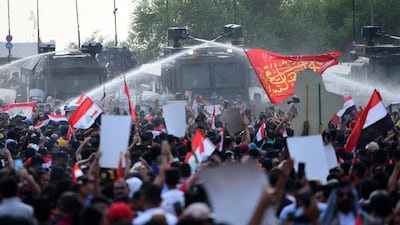 Iraqi riot police use water cannon in central Baghdad. EPA