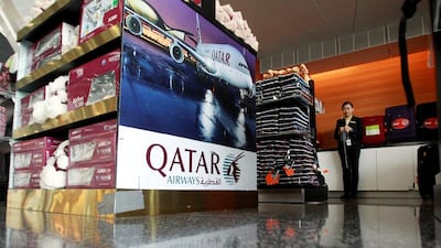 A sign of Qatar Airways is seen at Hamad International Airport in Doha. All international flights serving Qatar are banned from using Saudi and UAE airspace. Naseem Zeitoon / Reuters