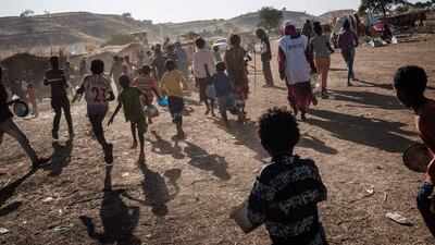 Ethiopian refugee children who fled the Tigray conflict run towards a food distribution by Muslim Aid at the Um Raquba refugee camp in Sudan's eastern Gedaref state. AFP