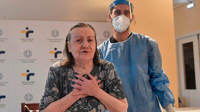 A woman shows gratitude after being vaccinated for Covid-19 in a nursing home in a north of Athens suburb in Greece. AFP