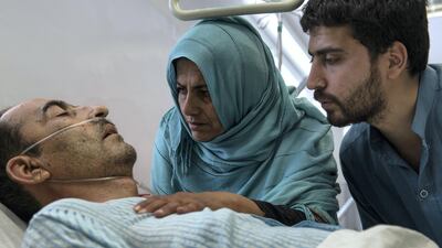 Shir Ali, 49, lies in hospital with his wife Qudsia, 48, and son by his side. The shock and pain of Monday's attack is raw. Stefanie Glinski for The National