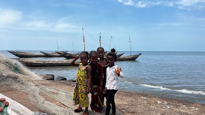 These girls may be too young to join the community’s fishing boats, but they help by untangling and repairing snagged nets. Nick Webster / The National