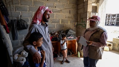 Ghiyath Ibn Ja’adan meets Bara'a al Okba of the Halo Trust, who asks him about dangerous objects he encounters in the fields. Ahmad Fallaha / The National
