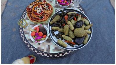A Palestinian family as they wait to break their fast together outside their shelter in Khan Younis, in the southern Gaza Strip on June 14, 2016. Photo by Ibraheem Abu Mustafa