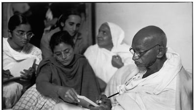 At Birla House, Delhi, in 1948, Mahatma Gandhi dictates a message before breaking his fast. This was one of the last images of the Indian leader before his assassination on January 30. Henri Cartier-Bresson / Magnum Photos