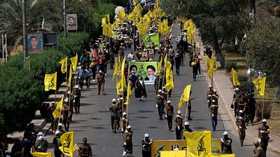 Iraqi Popular Mobilisation Forces march as they hold Popular Mobilisation flags and posters of Shiite spiritual leaders during Al-Quds Day (Arabic for Jerusalem) in Baghdad earlier this month. AP