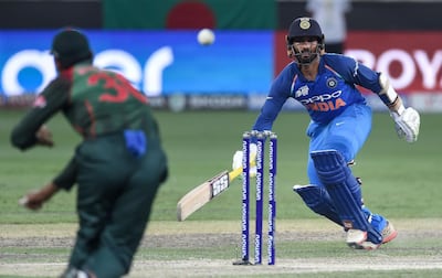 Indian batsman Dinesh Karthik (R) runs between the wickets during the final one day international (ODI) Asia Cup cricket match between Bangladesh and India at the Dubai International Cricket Stadium in Dubai on September 28, 2018. / AFP / ISHARA S. KODIKARA