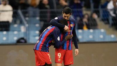 Robert Lewandowski (r) celebrates with Ousmane Dembele after putting Barca ahead in the first half. AP