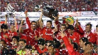 With the Copa Libertadores held aloft, Internacional players celebrate after beating Mexico's Chivas 3-2 on aggregate in the final. Jefferson Bernardes / AFP