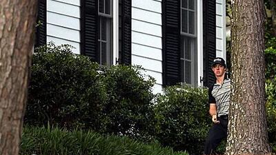 Rory McIlroy tries his way out from the 10th hole after an errant tee shot. His game fell apart with the triple bogey here. Andrew Redington / Getty Images