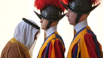 A member of Bahrain's delegation walks past Vatican Swiss Guards after the arrival of Prime Minister Salman bin Hamad Al Khalifa for a private meeting with Pope Leo XIV, in the Courtyard of St Damasus. AP