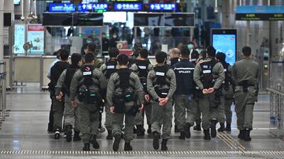 Police officers wearing facemasks as a preventative measure following a coronavirus outbreak which began in the Chinese city of Wuhan patrol at Shenzhen Bay Port Hong Kong Port Area on February 8, 2020. AFP