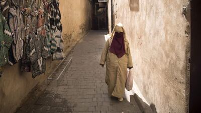 A Moroccan woman walks in the 9th century walled medina in the ancient city of Fez on April 11, 2019. AFP