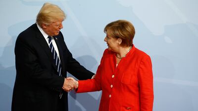 German chancellor Angela Merkel welcomes US president Donald Trump as he arrives to attend the G20 summit in Hamburg. Odd Andersen / AFP