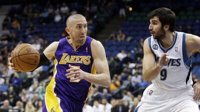 Los Angeles Lakers' Steve Blake, left, recorded his first career triple-double on Wednesday night as the Lakers edged past the Cleveland Cavaliers. AP Photo/Jim Mone
