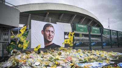Yellow flowers are displayed in front of the portrait of Argentinian forward Emiliano Sala at the Beaujoire Stadium in Nantes, France. AFP