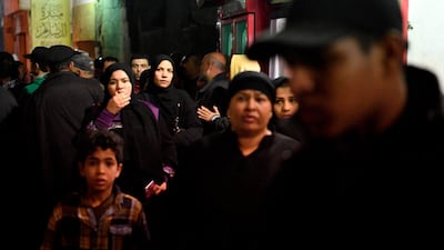 Members of the public crowd together at the site. AFP