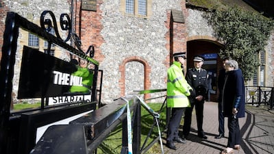 British Prime Minister Theresa May stands outside The Mill pub during a visit to the city where former Russian intelligence officer Sergei Skripal and his daughter Yulia were poisoned with a nerve agent (Photo by Toby Melville - WPA Pool/Getty Images)