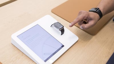 A visitor looks at the Apple Watch at the media preview of the Apple Store in Mall of the Emirates. Reem Mohammed / The National