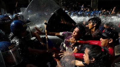 Protesters clash with anti-riot police officers as they try to march towards the US embassy during a rally against US president Donald Trump's visit, in Manila, Philippines. Athit Perawongmetha / Reuters