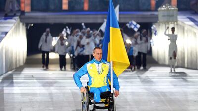 Flag bearer Mykhailo Tkachenko of Ukraine makes his entrance at Friday night's Paralympic Games opening ceremonies. Sergei Chirikov / EPA / March 7, 2014