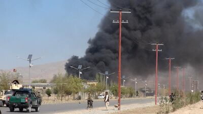 Smoke rises from police headquarters while Afghan security forces keep watch after a suicide car bomber and gunmen attacked the provincial police headquarters in Gardez, the capital of Paktia province, Afghanistan on October 17, 2017. Reuters