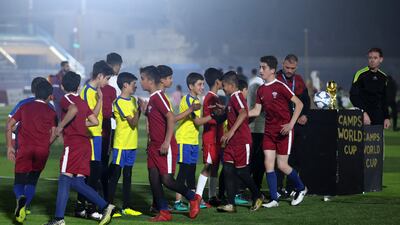 Children shake hands after the game