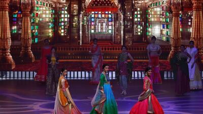 Models present creations by Indian designer Masuma Namjoshi during the IIFA Rocks event