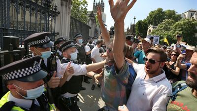 Protesters confront a police line outside the House of Commons during a freedom protest in London.