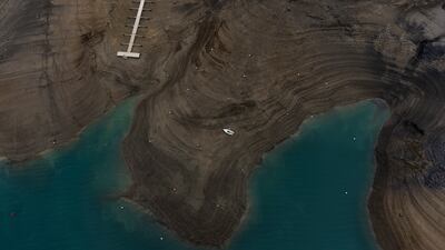 A boat lies stranded above the waterline at Serre-Poncon lake in southern France, after a prolonged winter drought. AP