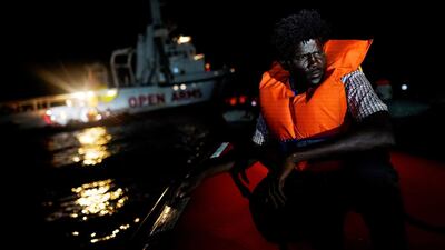 A migrant sits on board a rescue boat in the central Mediterranean Sea. Reuters