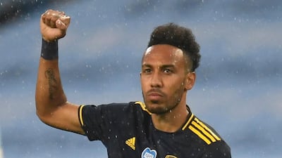 Arsenal's Pierre-Emerick Aubameyang gestures as he takes a knee before the match at Manchester City. Reuters