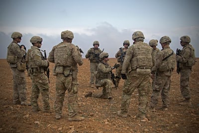 US soldiers gather for a brief during a combined joint patrol rehearsal in 2018 in Manbij, Syria. AP Photo