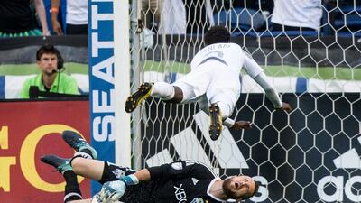 Minnesota United forward Abu Danladi fouls Seattle Sounders goalkeeper Stefan Frei and gets a yellow card during the first half of an MLS football match in Seattle. Bettina Hansen / The Seattle Times via AP