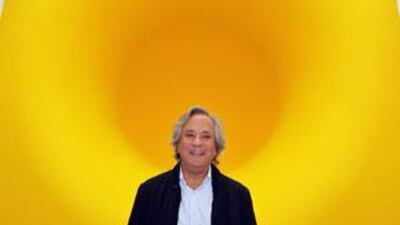 Anish Kapoor with his sculpture Yellow at The Royal Academy in London. The exhibition of Kapoor's work explores texture, scale and the way observers interact with art.